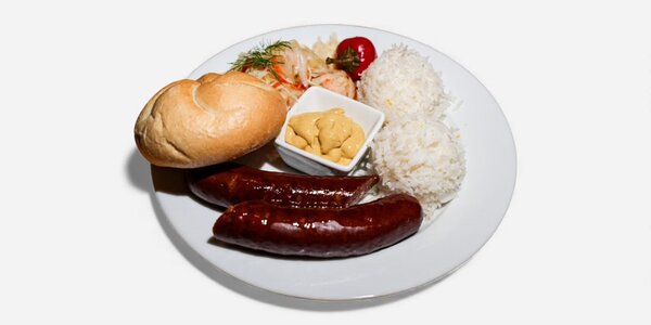 Homemade dark fried pork sausage with a bun, side dish and salad of choice