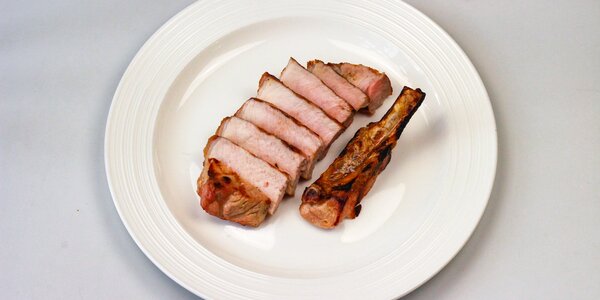 pork loin on the bone grilled over the wood charcoals